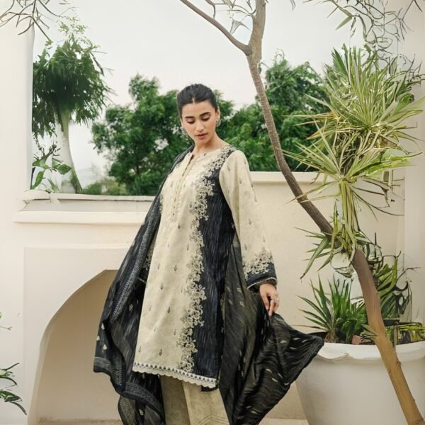 Woman in cream and navy traditional outfit with embroidery, standing outdoors