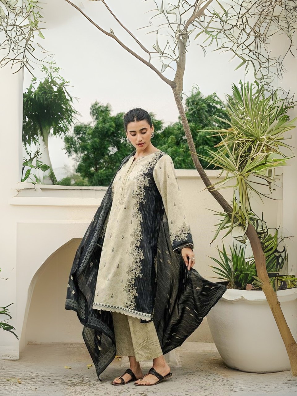 Cream Embroidered Kurta with Navy Dupatta – Elegant Outdoor Look Woman in cream and navy traditional outfit with embroidery, standing outdoors