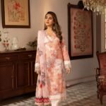 Woman in floral printed pink traditional dress indoors